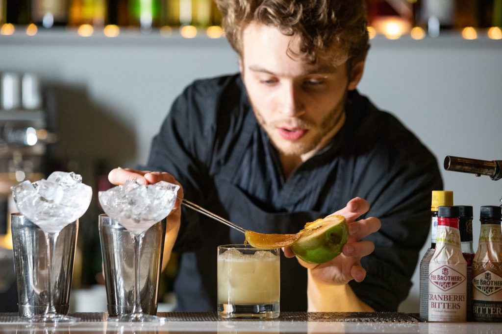 A picture of a Bartender making a drink at Artson