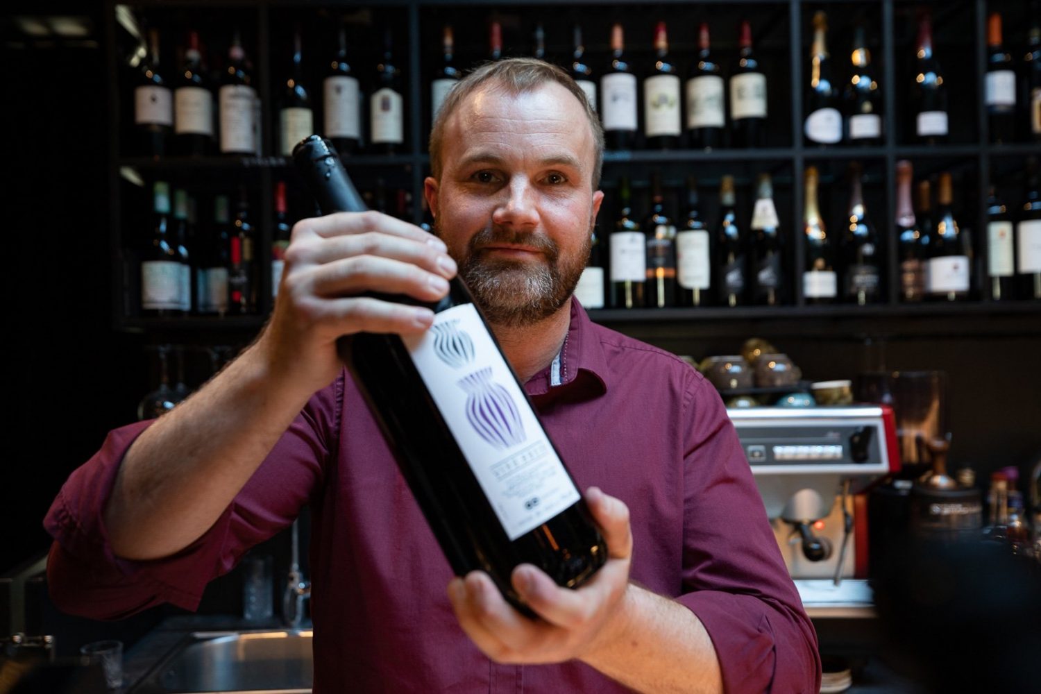 A bartender with a bottle of wine at port 9