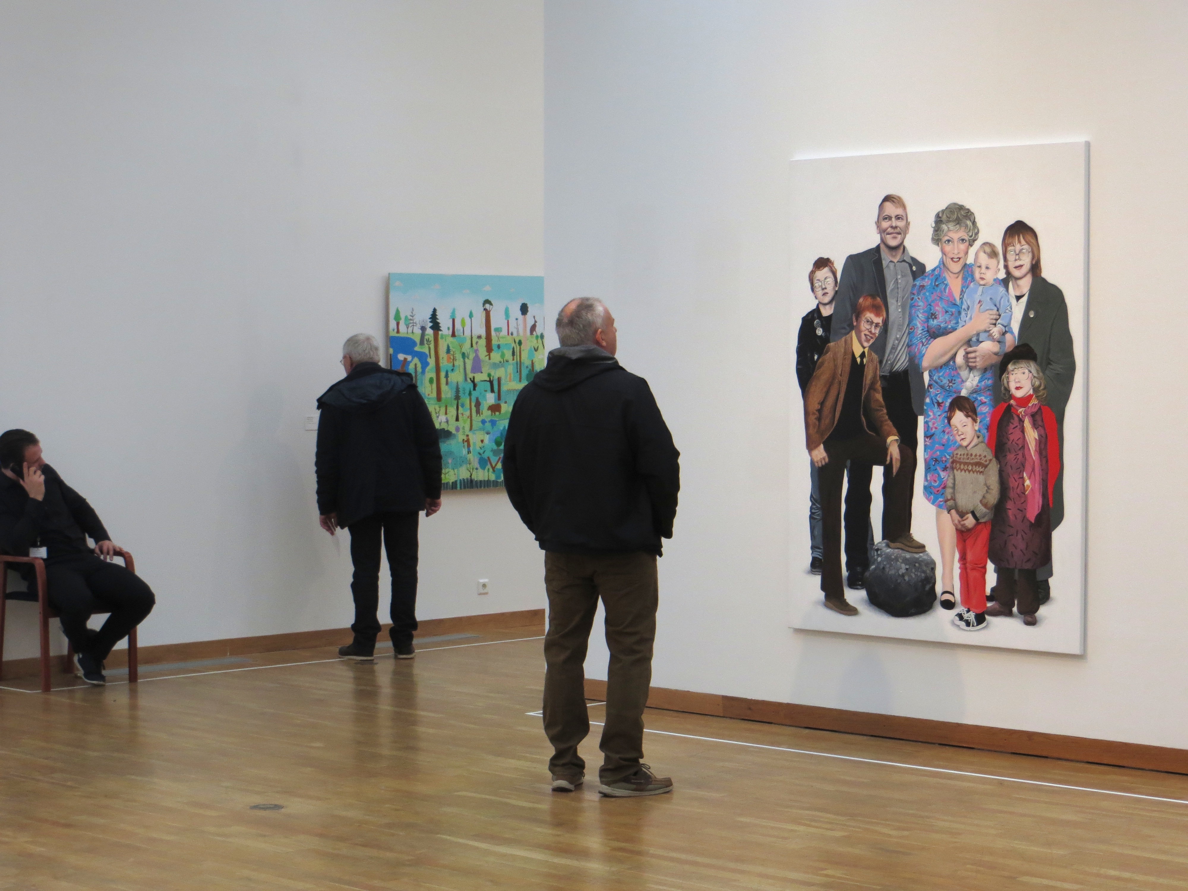 Viewers at Kjarvalsstaðir take in Hallgrímur Helgasons 'The Gnarr Family' by Hallgrímur Helgason